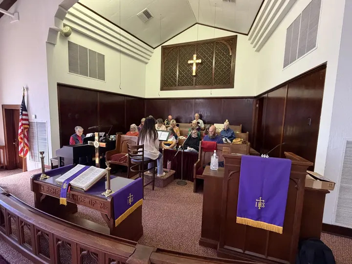 The chancel draped in purple paraments for Lent, with the altar and pulpit dressed for the season.